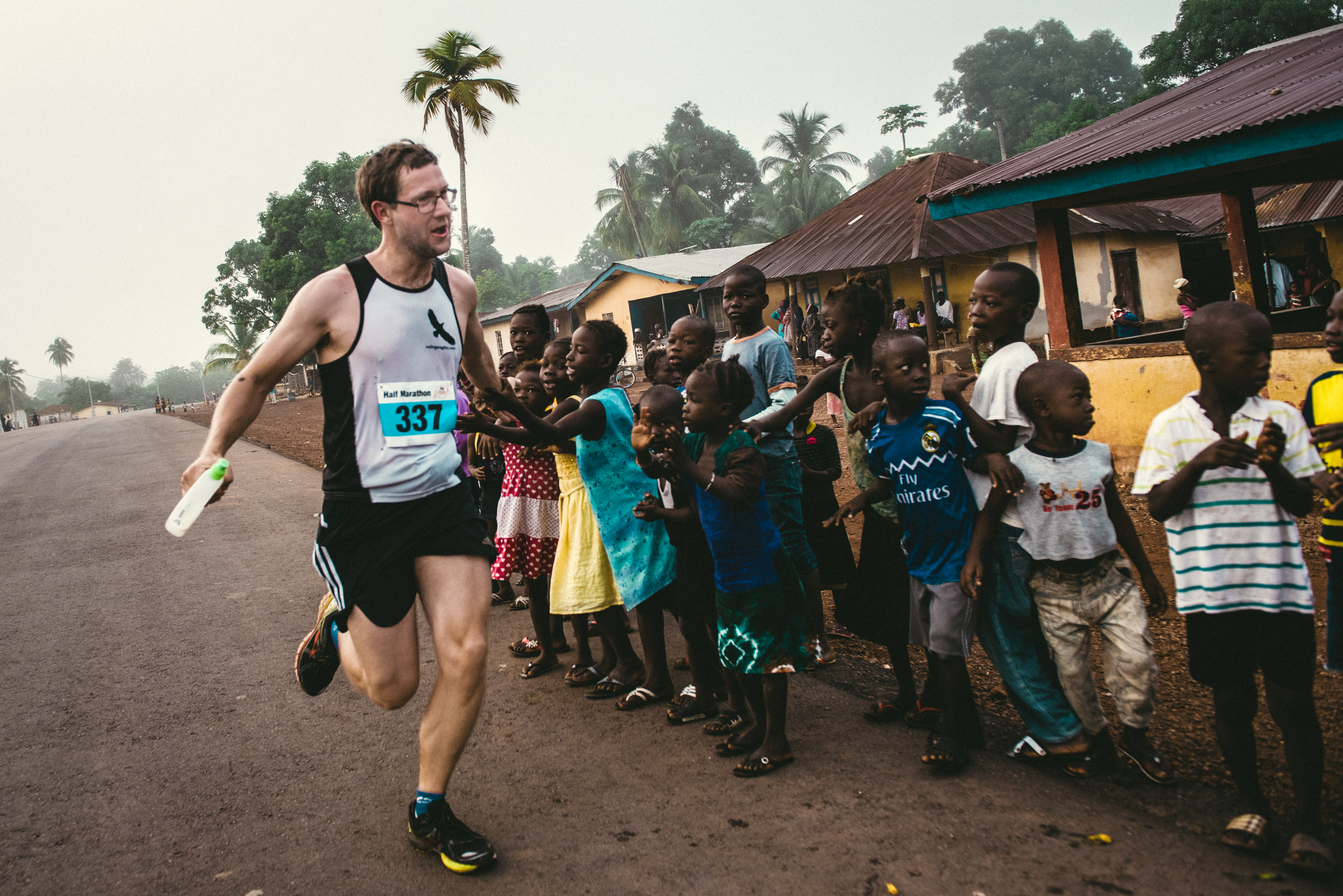 Andy high-fives children while running